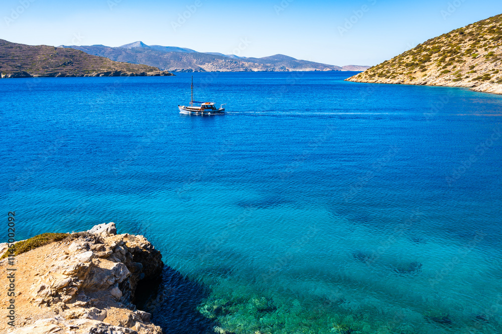 Fishing boat on azure blue sea near Maltezi bay, Amorgos island, Cyclades, Greece