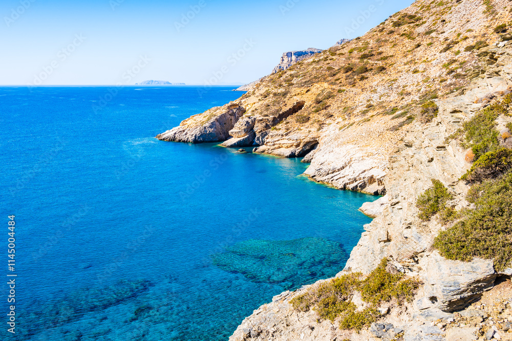 View of Mouros bay with azure blue sea and high cliffs, Amorgos island, Cyclades, Greece View of Mouros bay with azure blue sea and high cliffs, Amorgos island, Cyclades, Greece