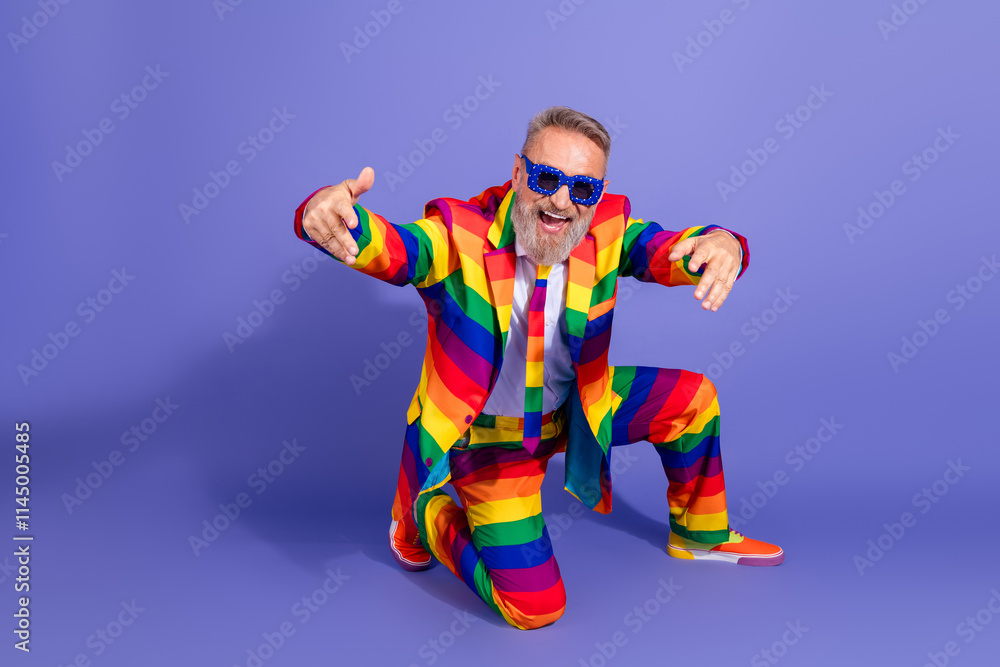 Eccentric senior gentleman in a rainbow suit celebrating diversity and pride Eccentric senior gentleman in a rainbow suit celebrating diversity and pride