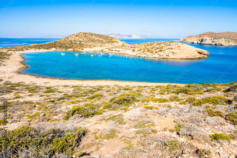 Boats in sea bay of Kalotaritissa with beautiful sandy beach, Amorgos island, Cyclades, Greece