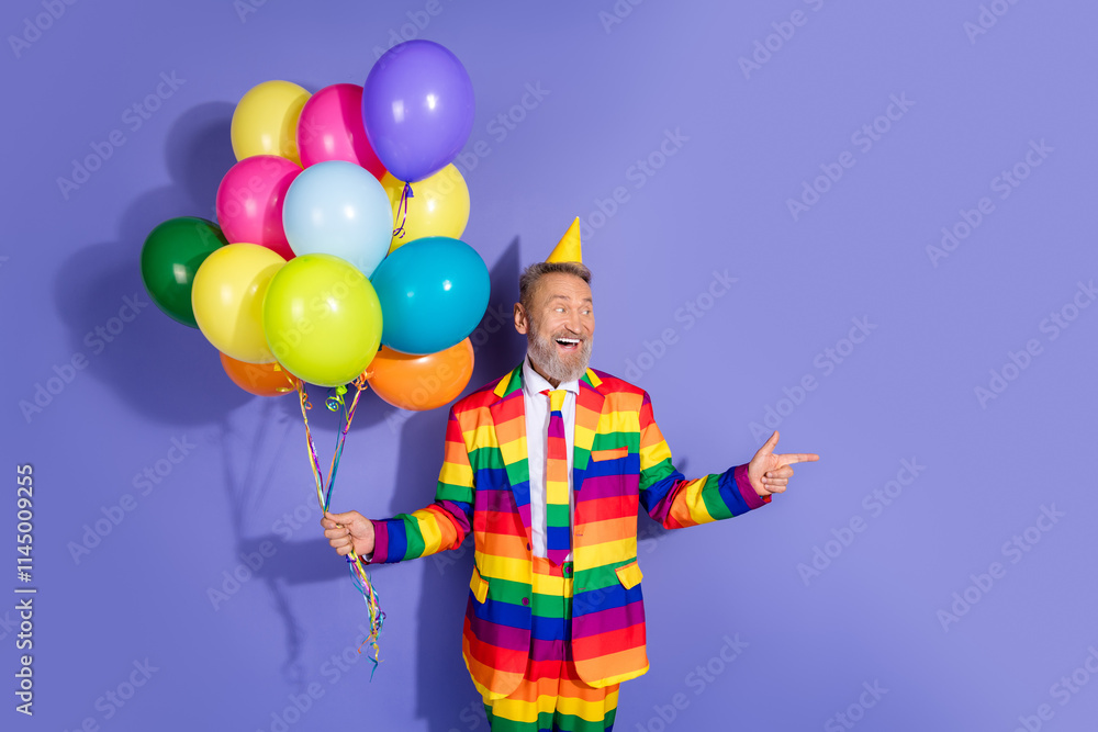 Elderly man in rainbow attire holding balloons on purple background, smiling joyfully, celebrating diversity and style with a party hat Elderly man in rainbow attire holding balloons on purple background, smiling joyfully, celebrating diversity and style with a party hat