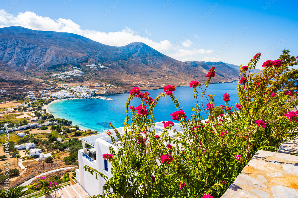 Colorful flowers and tropical plants in Tholaria village with sea and mountains in background, Amorgos island, Cyclades, Greece