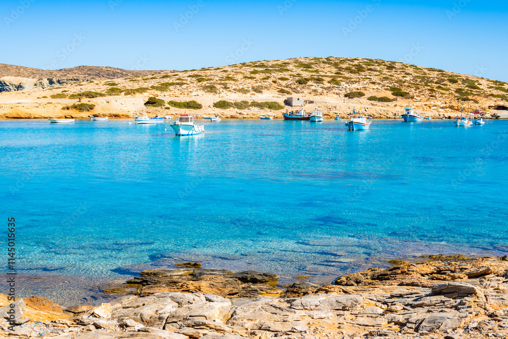 Boats in sea bay of Kalotaritissa with beautiful sandy beach, Amorgos island, Cyclades, Greece
