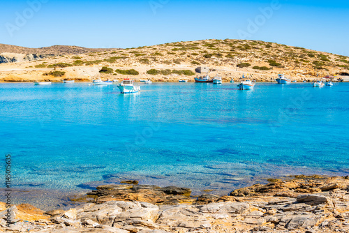 Boats in sea bay of Kalotaritissa with beautiful sandy beach, Amorgos island, Cyclades, Greece photo