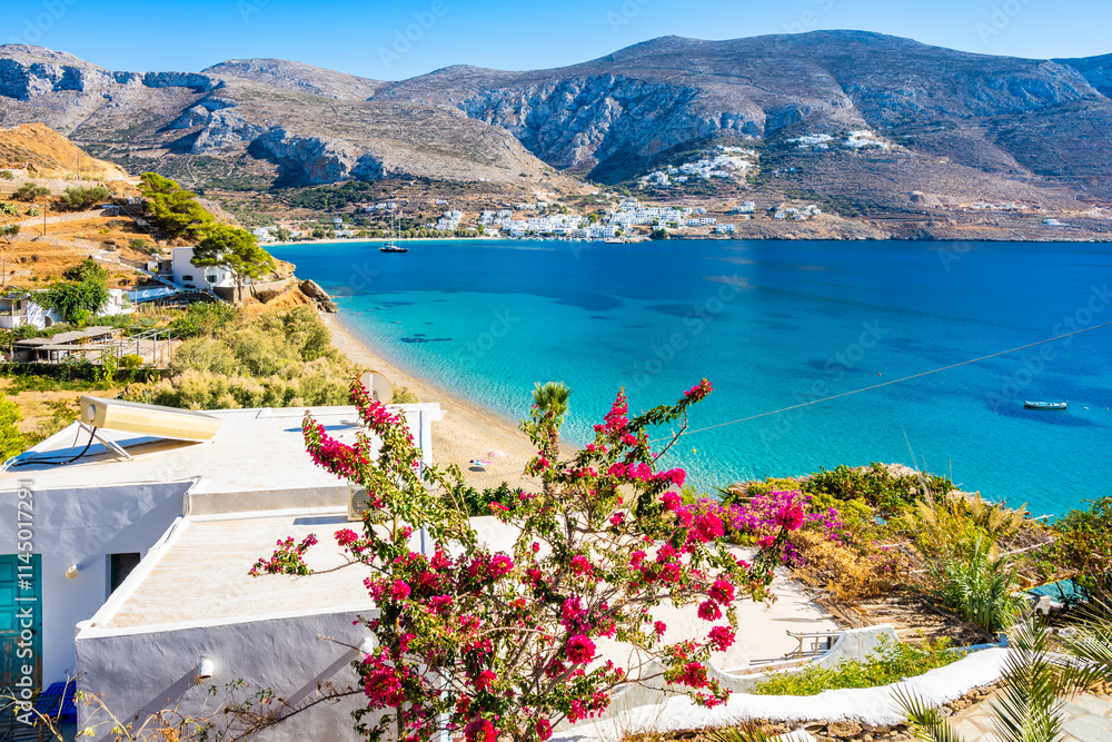 Houses and apartments decorated with flowers and tropical plants in Levrossos bay, Amorgos island, Cyclades, Greece