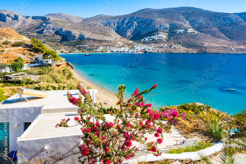 Obraz na płótnie Houses and apartments decorated with flowers and tropical plants in Levrossos bay, Amorgos island, Cyclades, Greece w salonie