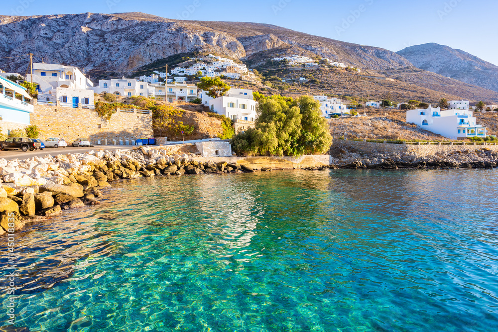 Houses on sea coast in Aigiali port (Ormos Egialis) at sunset, Amorgos island, Cyclades, Greece