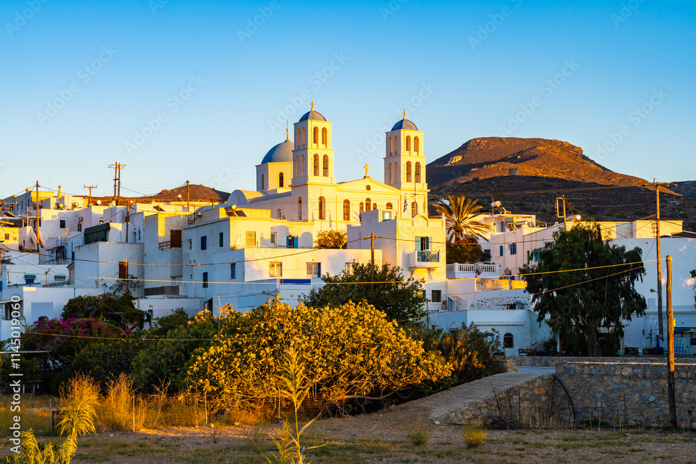 Church building and village houses in sunset light in Katapola port
