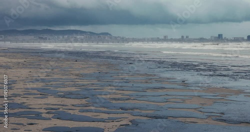 Oil in sea coastline leaked after a tanker wreck. Fuel Oil polluted and destroy beach