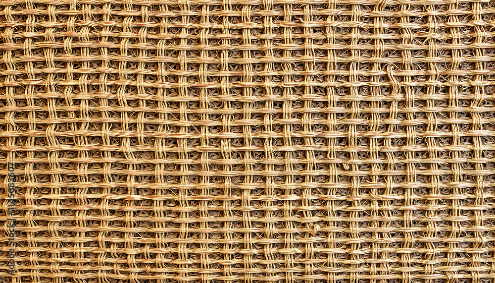 Woven natural fiber texture in a light brown color for design and backgrounds Woven natural fiber texture in a light brown color for design and backgrounds