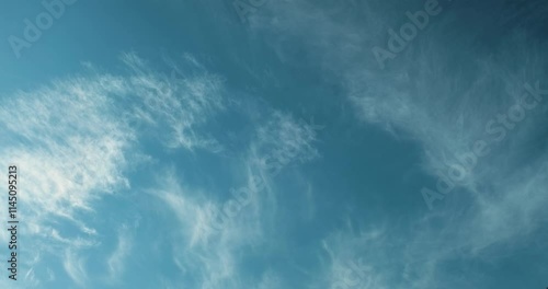 Timelapse of beautiful view of delicate ethereal whispy white cirrus clouds in the clear azure blue sky on a sunny day reminding of foam on the sea surface 