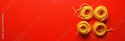 Fresh pasta nests on a vibrant red background, ideal for culinary themes, restaurant menus, food blogs, and Italian cuisine promotions.