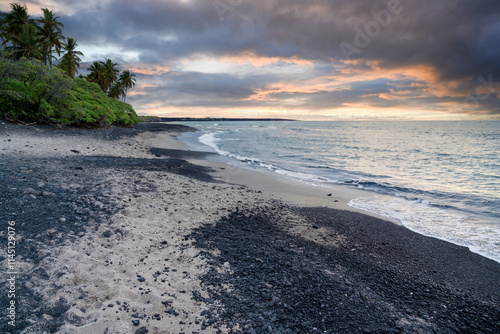 Beach with white coral sand and black volcanic sand on the shores of Big Island, Hawaii