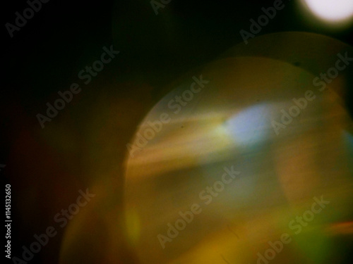 Abstract light leak effect on dark background for creating special effects. The colors are vibrant and the circles are overlapping, creating a sense of movement and energy. Abstract art. photo