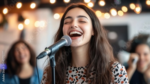 Joyful young woman singing passionately into microphone surrounded by creative atmosphere and warm lights