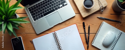 Modern wooden office desk with laptop computer smartphone, notebook. Empty space for new ideas. Work from home setup. Minimalist design with tech accessories. Perfect background for productivity photo