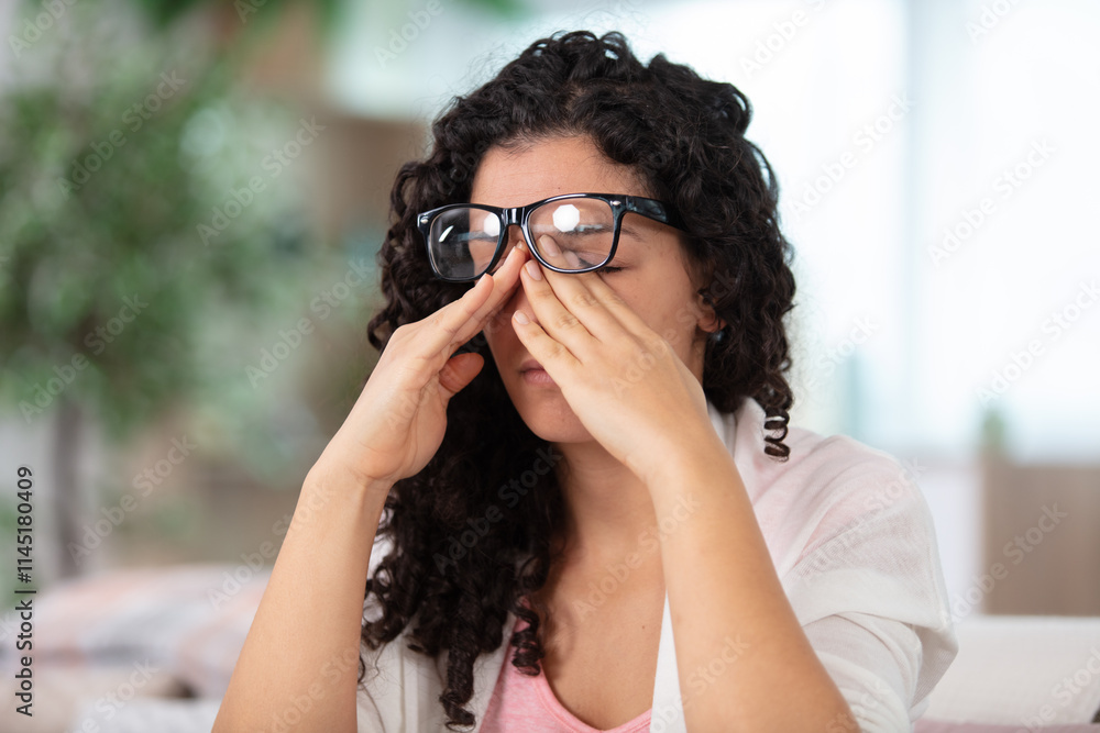 depressed young woman sitting on sofa at home depressed young woman sitting on sofa at home