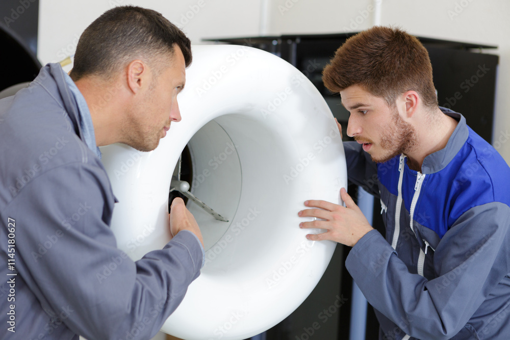Obraz premium portrait of men reparing a wind turbine