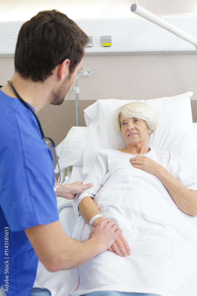 Fototapeta premium male doctor listening to senior patient
