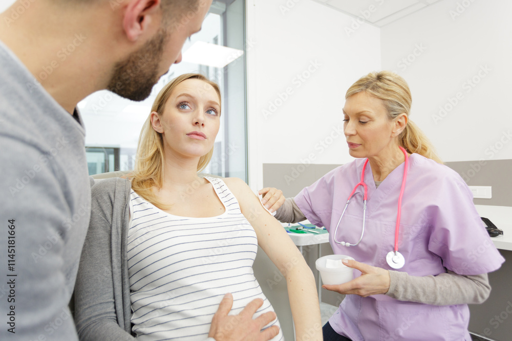 Fototapeta premium loving couple attending doctor for pregnancy ultra sound procedure