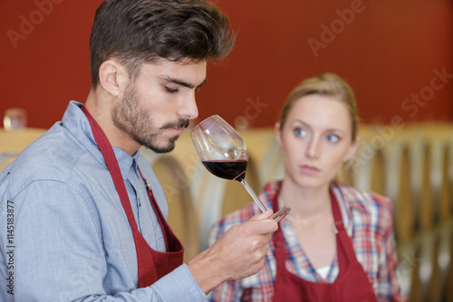 professional taster of winery tasting wine in a cellar photo