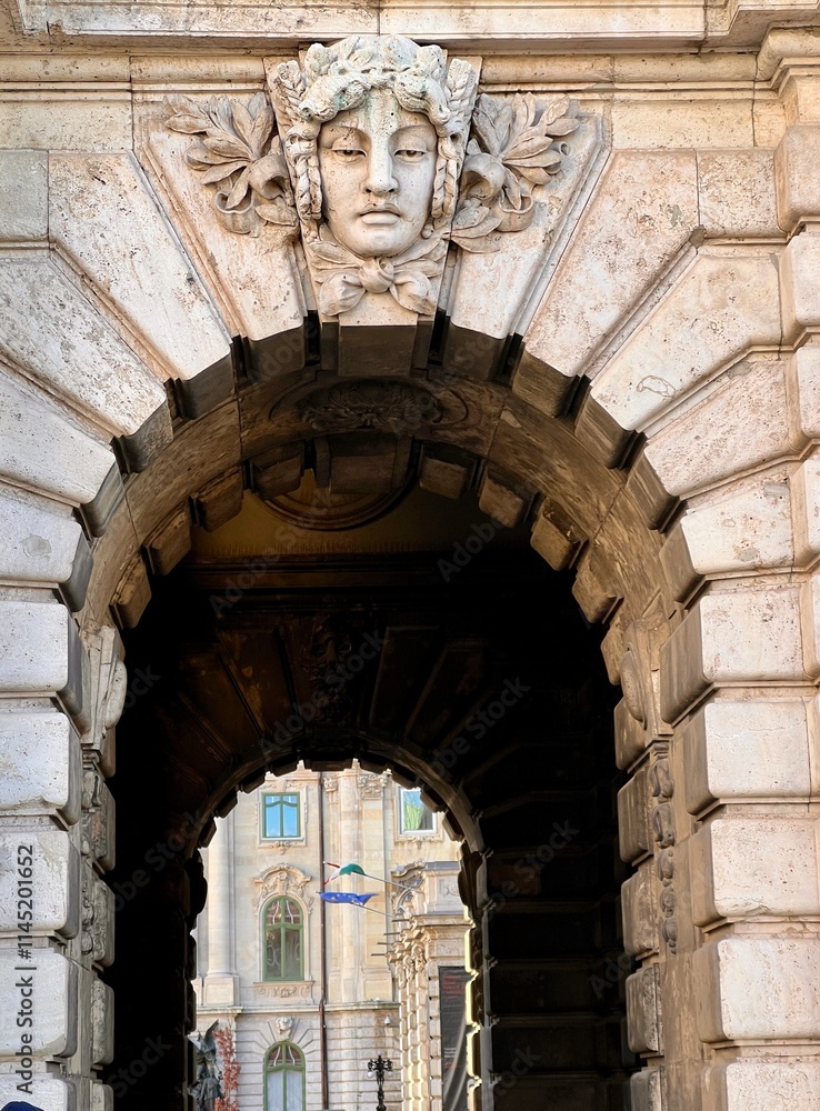 Fototapeta premium ornate stone archway with carved face in budapest