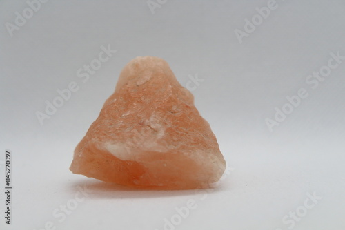 A close-up of Himalayan pink salt or halite rock isolated on a white background  photo