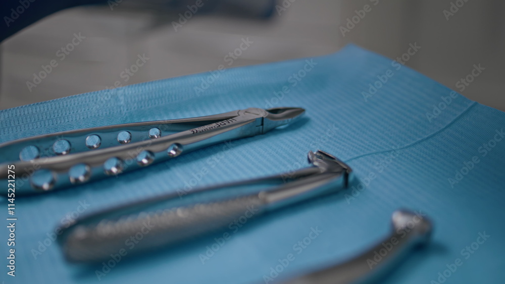Closeup sterilized dental tools arranged on blue cloth modern clinic. Dentistry 