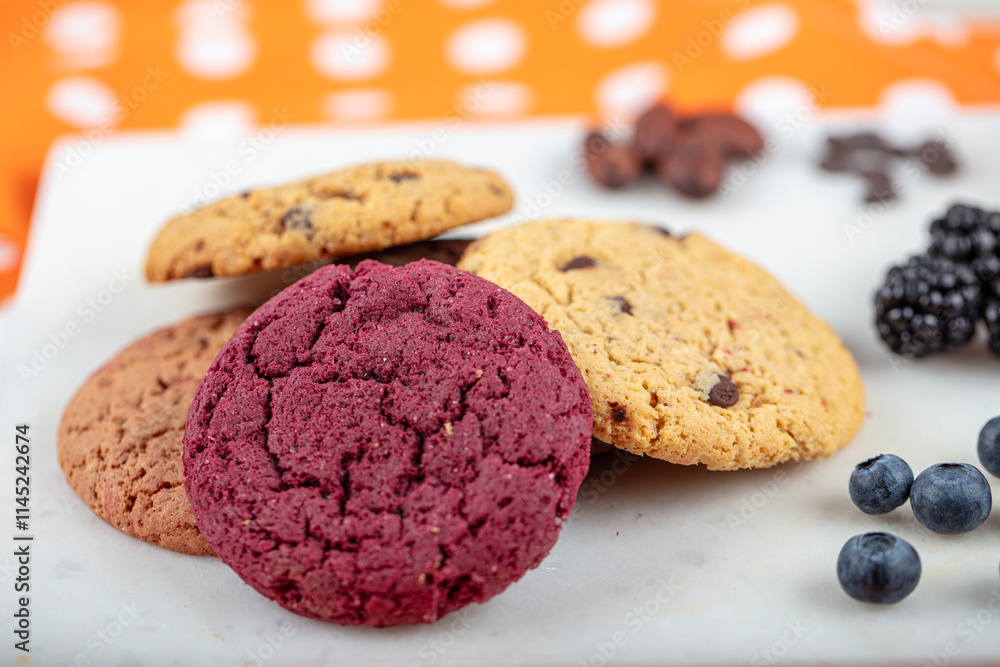 Cookie, Close-up of oatmeal cookies with raisins and chocolate on a plate in warm colors with a blurred background. Healthy Food Snack Concept. Cookie, Close-up of oatmeal cookies with raisins and chocolate on a plate in warm colors with a blurred background. Healthy Food Snack Concept.
