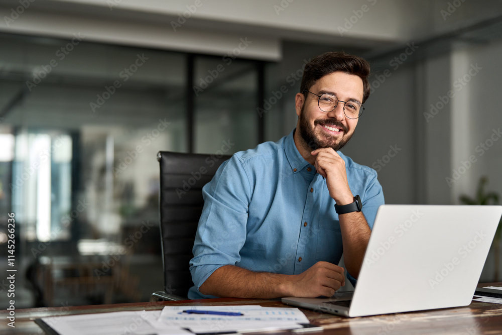 Portrait of happy professional business man company employee, young smiling male businessman entrepreneur or worker looking at camera using laptop computer technology working at corporate office desk. Portrait of happy professional business man company employee, young smiling male businessman entrepreneur or worker looking at camera using laptop computer technology working at corporate office desk.