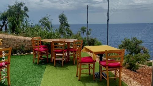 Decorated table on the grass patio near the sea. High quality 4k footage