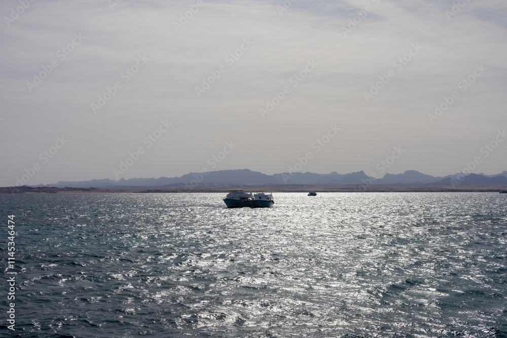 Tranquil ocean view with boats on a sparkling water horizon Tranquil ocean view with boats on a sparkling water horizon