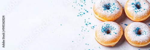 Sufganiyot traditional Hanukkah donuts are beautifully arranged with powdered sugar and blue sprinkles on a white background creating a festive atmosphere for the holiday photo