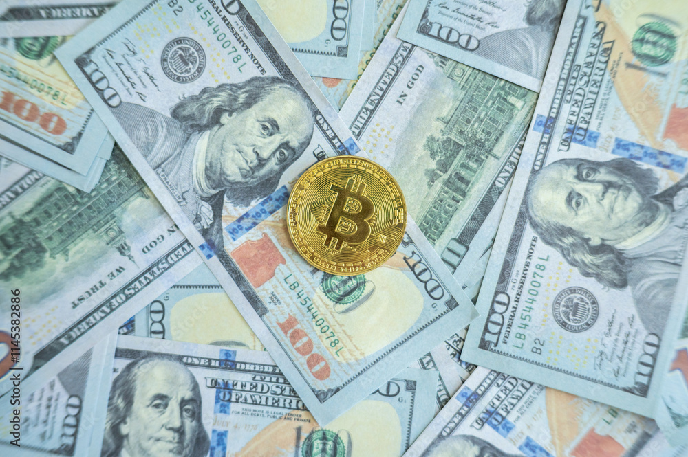 A Bitcoin token placed on America one hundred dollars banknote. Bitcoin is a digital currency which operates free of any central control or the oversight of banks or governments. A Bitcoin token placed on America one hundred dollars banknote. Bitcoin is a digital currency which operates free of any central control or the oversight of banks or governments.
