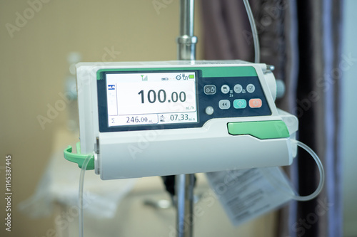 Close up of an external infusion pump is a medical device used to deliver fluids into a patient's body in a controlled manner. photo