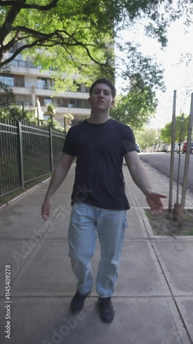 Young latin male influencer walks and talks to camera