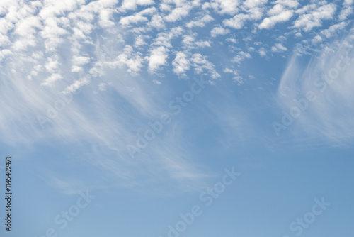 Layer of white puffy clouds, Cirrus and Altocumulus, against a dark blue sky, atmospheric phenomenon as a light filled nature background
 photo