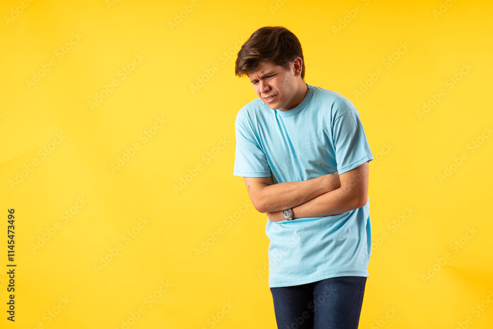 Young person expressing various emotions and body pains, pointing, using a cellphone, with colored backgrounds and wearing shirts of different colors Young person expressing various emotions and body pains, pointing, using a cellphone, with colored backgrounds and wearing shirts of different colors