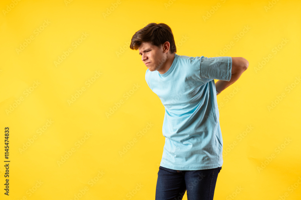 Young person expressing various emotions and body pains, pointing, using a cellphone, with colored backgrounds and wearing shirts of different colors Young person expressing various emotions and body pains, pointing, using a cellphone, with colored backgrounds and wearing shirts of different colors
