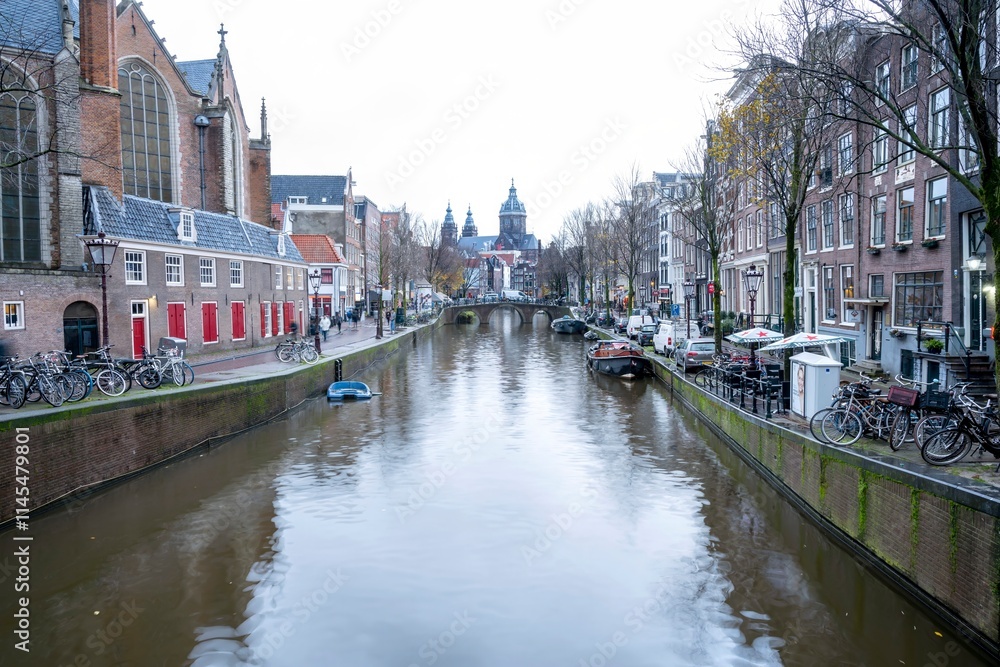 Obraz premium Cityscapes of Amsterdam with canal and bridge with St. Nicholas Church view