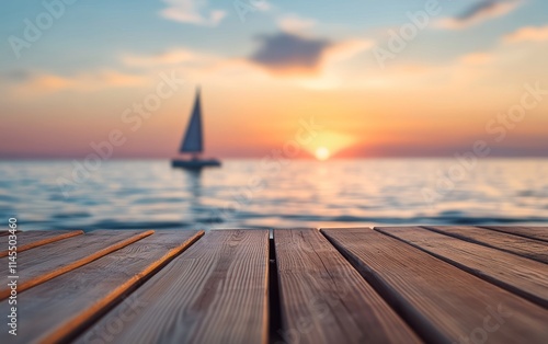 A serene sunset view over a calm sea with a sailboat in the distance.