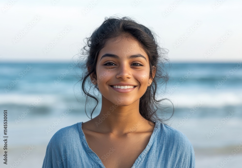 Young woman smiling joyfully at the beach with waves in the background, radiating happiness and serenity in natural sunlight, perfect for summer lifestyle themes. Young woman smiling joyfully at the beach with waves in the background, radiating happiness and serenity in natural sunlight, perfect for summer lifestyle themes.