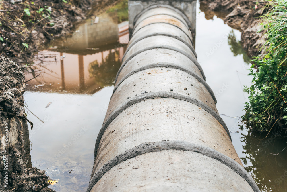 Large water pipes are laid in ditches for drainage system installation,supported by excavators.This construction work focuses on urban infrastructure development,showcasing efficient engineering Large water pipes are laid in ditches for drainage system installation,supported by excavators.This construction work focuses on urban infrastructure development,showcasing efficient engineering