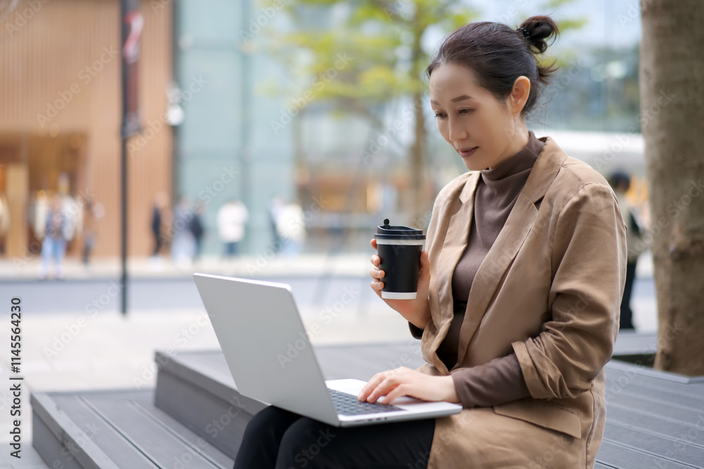 Modern Professional Woman Working Outdoors with Laptop and Coffee Modern Professional Woman Working Outdoors with Laptop and Coffee