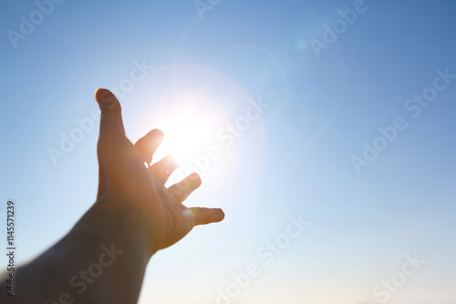 Sticker New Year's sunrise, the bright light shining through the fingers and hands stret