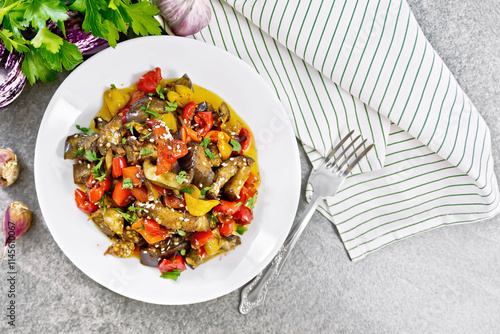 Ragout of eggplant with sweet peppers on granite table top photo