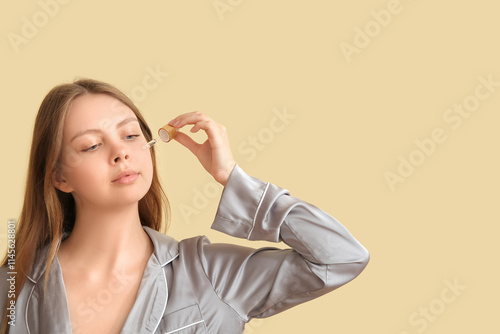 Young woman applying facial...