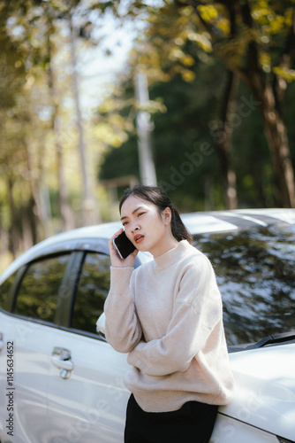 Asian woman calls insurance company for help after car accident photo