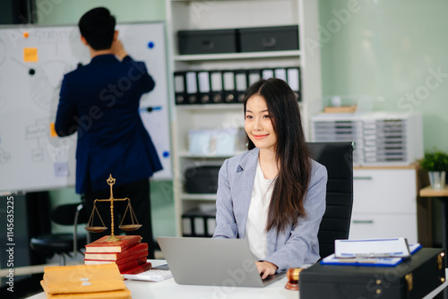 Beautiful asian woman lawyer working and gavel, tablet, laptop in front, Advice justice