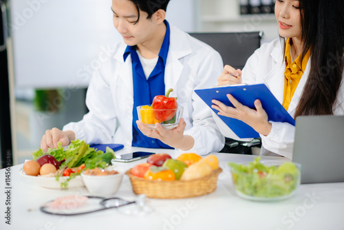 Doctors sharing fresh vegetables, promoting health and nutrition. Ideal for wellness, healthcare, and science themes. photo